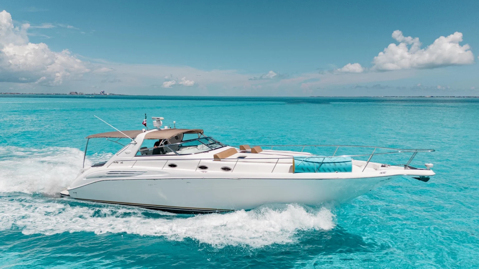 Yacht cruising turquoise waters in Cancun